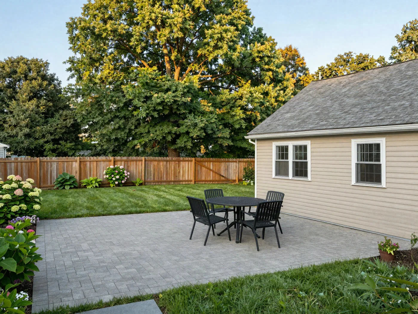 Fenced rear yard with paver patio