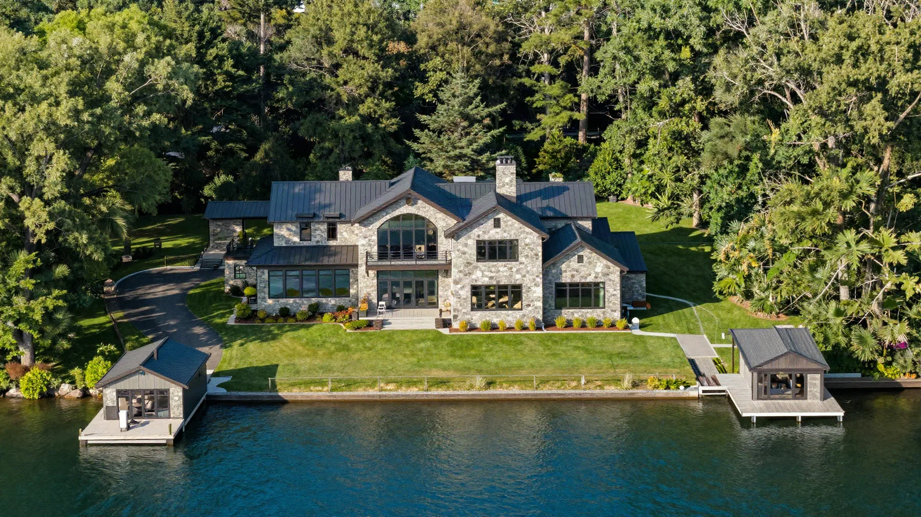 Aerial view of the full 1.8-acre property, lawn, dock and shoreline